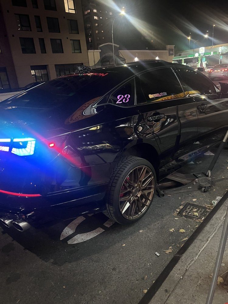 A car in the bay for tyres, lit up while it is worked on